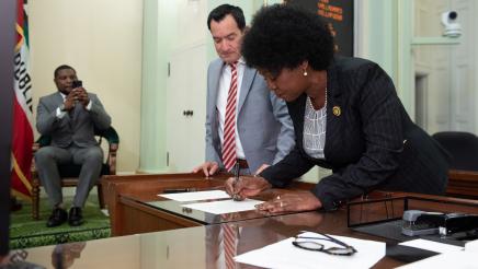 Asm. McKinnor signing document