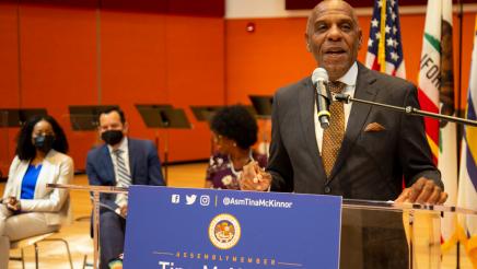 State Senator Steven Bradford at podium, speaking