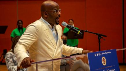 Isadore Hall, III at podium, speaking