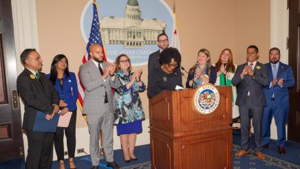 Asm. McKinnor being applauded by fellow legislators and guest speakers