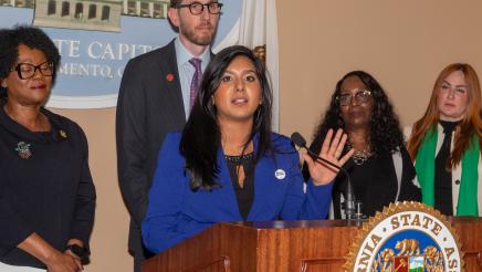 Shubhangi Domokos, Chief of Staff of the California Labor Federation at podium