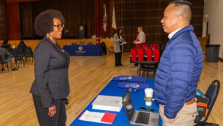 Asm. McKinnor speaks with display table staffer
