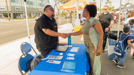 Asm. McKinnor shakes hands with resource booth staffer