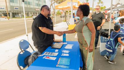 Asm. McKinnor shakes hands with resource booth staffer