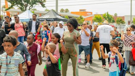Asm. McKinnor dancing with young students