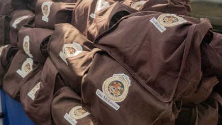 Bags with Asm. McKinnor's logo on them displayed on tables