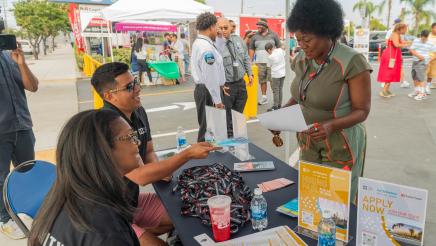 Asm. McKinnor speaking with resource booth staffers