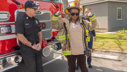 Asm. McKinnor trying on firefighting coat