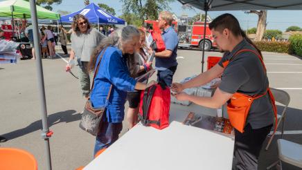 Home Depot staffers revewing emergency kit with attendee