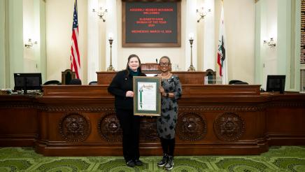 Asm. McKinnor honoring Elizabeth Kane as Woman of the Year on the Assembly Floor