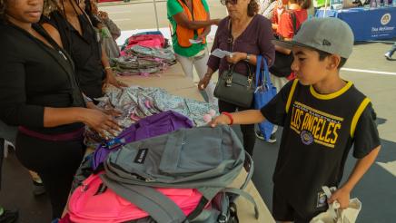 Student selecting backpack