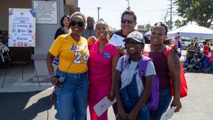Asm. McKinnor and Councilmember Faulk with backpack recipient
