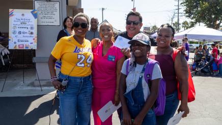 Asm. McKinnor and Councilmember Faulk with backpack recipient