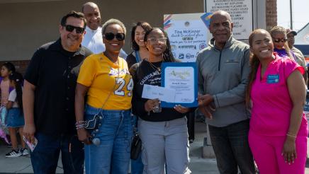 Asm. McKinnor awarding scholarship to student, with Sen. Bradford and others