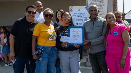 Asm. McKinnor awarding scholarship to student, with Sen. Bradford and others