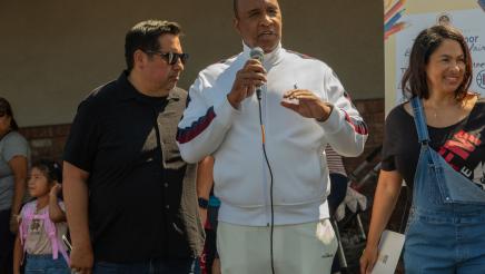 Guest speaker holding microphone and speaking