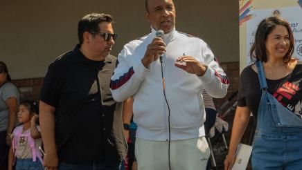 Guest speaker holding microphone and speaking