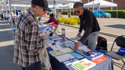 LA Emergency Management Dept. representative providing constituent with materials