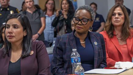 Asm. McKinnor, seated with other legislators, listening on
