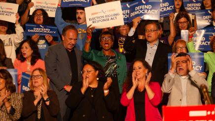 Asm. McKinnor, other legislators and supporters cheering, some holding signs