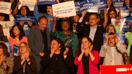 Asm. McKinnor, other legislators and supporters cheering, some holding signs