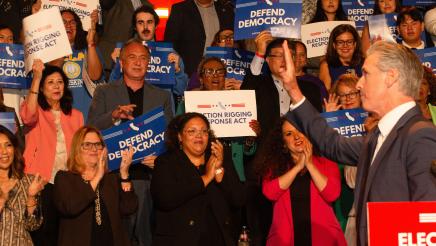 Asm. McKinnor, other legislators and supporters cheering as Gov. Newsom waves