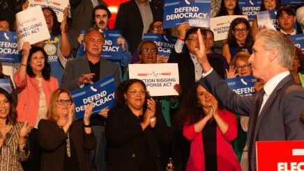 Asm. McKinnor, other legislators and supporters cheering as Gov. Newsom waves