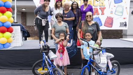 Asm. McKinnor onstage with others, presenting winners with bicycles
