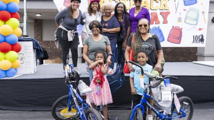 Asm. McKinnor onstage with others, presenting winners with bicycles