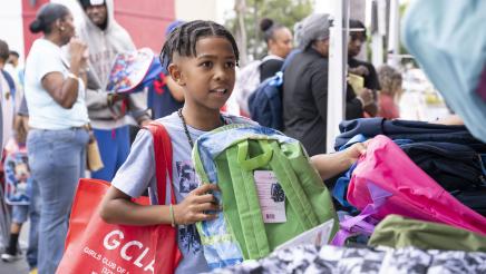 Child receiving backpack