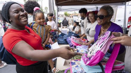 Asm. McKinnor sharing a light moment with mother and child